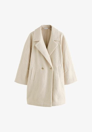 Beige dobbeltrækket frakke i et tekstureret stof, med store klaplapper, to forlommer og afslappet pasform. Lange ærmer, ingen synlige lukninger.