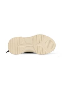 Beige rubber sneaker sole with textured pattern, featuring horizontal and vertical grooves for grip, and a rounded toe design.