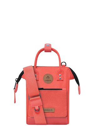 Coral canvas crossbody bag with a top handle, adjustable strap, front zip pocket, and a branded leather patch. Features snap and zipper closures.