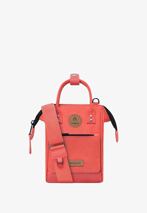 Coral canvas crossbody bag with a top handle, adjustable strap, front zip pocket, and a branded leather patch. Features snap and zipper closures.