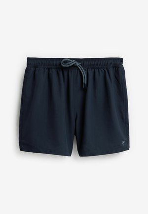 Bañador azul marino hecho de una tela suave, con una cinturilla elástica con cordón y dos bolsillos laterales. Detalle del logo en la pierna.