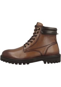 Bottines en cuir marron avec un bout rond, des lacets, des accents marron foncé au col et une semelle extérieure noire robuste avec des crampons.