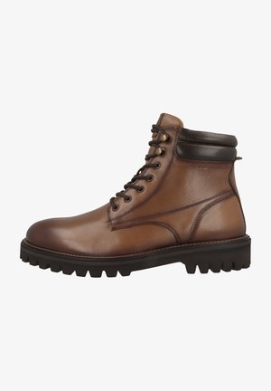 Brown leather ankle boots with a rounded toe, lace-up design, dark brown accents at the collar, and a rugged black outsole with treads.