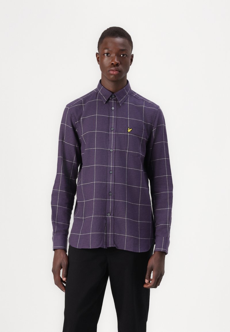 Purple checkered shirt with long sleeves, button-down collar, and yellow logo. Features a grid pattern with contrasting white lines.