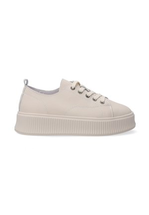 Cream-colored sneaker with a smooth leather upper, round toe, and a thick, ribbed sole. Features flat laces and a stitched design.