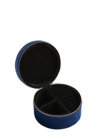 Round, navy blue velvet jewelry case with gold zipper. Interior features a soft black fabric lining and compartments for organizing items.