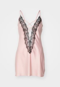 Pink satin nightdress with a deep black lace V-neckline, featuring crisscross straps and a frayed lace trim along the edges.