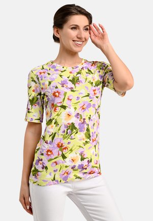 Blumen Kurzarmoberteil in Hellgrün mit lila, gelben und roten Blumenmustern. Glatter Stoff mit lockerer Passform und rundem Ausschnitt.