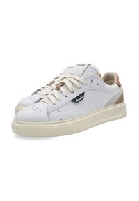 White leather sneakers with perforated detailing, beige accents, and a textured cream rubber sole. Features laces and logo patch.