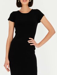 Czarna sukienka z prążkowanej tkaniny, z krótkimi rękawami i okrągłym dekoltem. Dopasowany krój podkreśla sylwetkę. Gładka faktura z minimalnymi detalami.