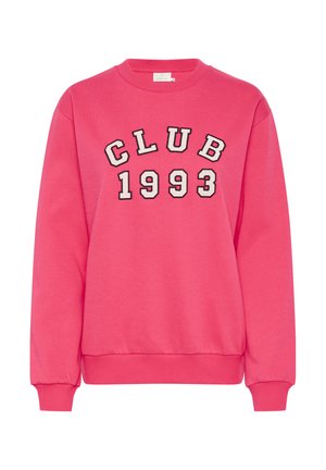 Rózsaszín pulóver, amelyen a "CLUB 1993" felirat szerepel vastag fekete betűkkel. Puha anyagból készült, bordás mandzsettákkal és aljjal. Egyenes fazon.