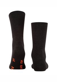 Meias pretas caneladas com detalhes em texto laranja nas laterais, exibindo as frases "LIKE LIGHT" e "05". Textura macia, design até ao tornozelo.