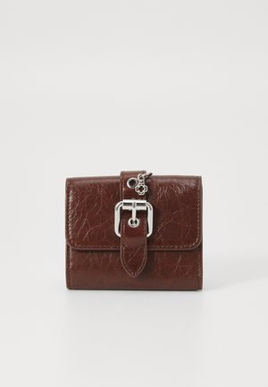 Portefeuille en faux cuir marron avec une finition texturée, doté d'une boucle en métal argenté et d'un petit charme, de forme rectangulaire compacte.