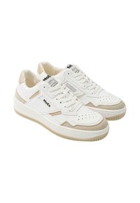 White sneakers featuring a mix of smooth and suede textures, with perforated detailing, beige accents, and black branding on the tongue.