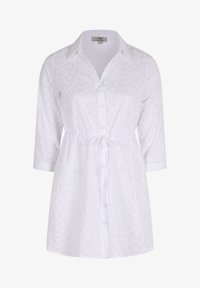 Witte blouse met 3/4 mouwen, oogjespatroon, strakke taille met strik en contrasterende kraag. Lichtgewicht stof met bloemdetails.