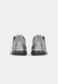 Gray and black athletic shoes with a mesh upper, reflective accents, and a cushioned sole. Features prominent logo and heel tab.