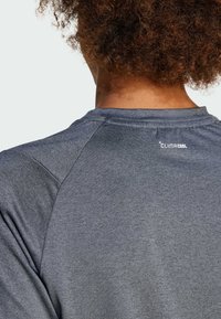 Gray athletic shirt with a moisture-wicking fabric, featuring a raglan sleeve design and the “Climacool” logo near the neckline.