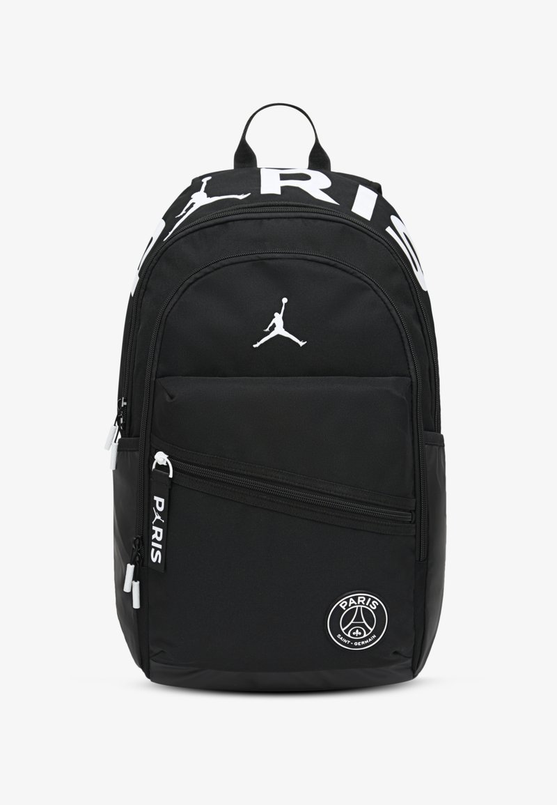 Black backpack with multiple zippered compartments. Features white "PARIS" lettering, a Jumpman logo, and a circular Paris emblem. Durable fabric.