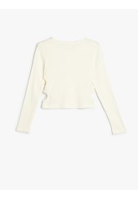 Cremfarbener, langärmliger, gerippter Crop-Top mit rundem Ausschnitt und seitlichen Cut-Outs, ausgestattet mit einer sanften Textur und enger Passform.