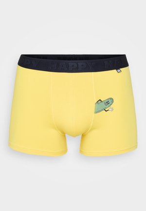 Gule boxershorts med sort linning og teksten "HAPPY"; har en tegneserie-illustration af en agurk på venstre ben.