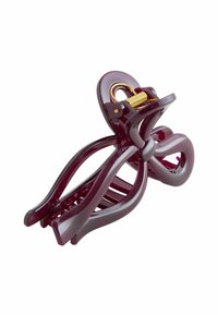 Violetinis plastikinis plaukų spaustukas su kreiviu dizainu, turintis auksinę spring mechanizmą ir kelis sukibimo dantis, užtikrinančius tvirtą plaukų laikymą.