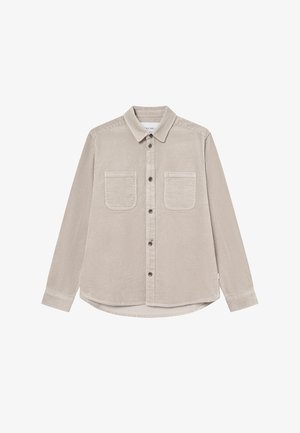 Beidža korduroja krekls ar garām piedurknēm, apkakles krūti, divām krūšu kabatām un izliekto apakšmalu. Pogājamā aizdare un teksturēts audums.