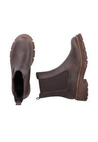 Bottines en cuir marron avec des panneaux élastiques sur les côtés, semelles en caoutchouc texturé et une languette de tirage. Bout arrondi et petit talon.