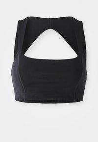 Sujetador deportivo negro con un cuello alto, diseño de espalda abierta y detalles de costura visibles. Fabricado con material suave y elástico para mayor comodidad.