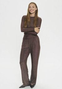 Sparkly brown long-sleeve top and matching wide-leg pants in a shimmering fabric, featuring a relaxed fit and elastic waistband.