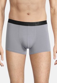 Gray boxer briefs with a black elastic waistband, featuring a smooth texture and a fitted design that extends to mid-thigh.
