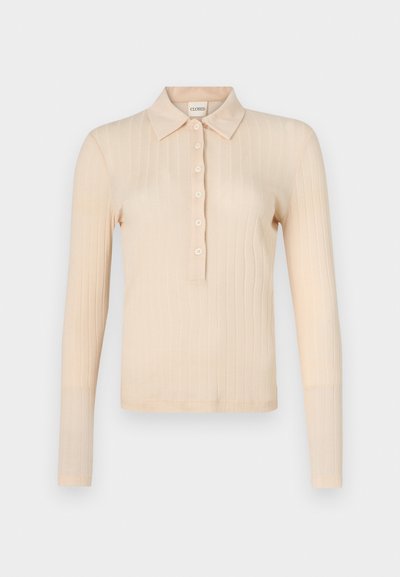 Gara piedurkne polo krekliņš gaiši persiku krāsā no ribota auduma, ar apkakles dekoltē, septiņām pogām un pieguļošu siluetu.