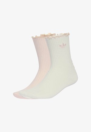 Paio di calzini a coste rosa pallido e bianco sporco, con polsini arricciati e piccolo logo ricamato vicino alla parte superiore.