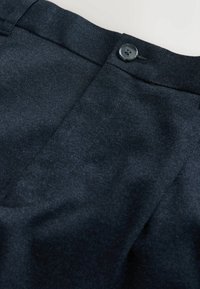 Navy blue trousers made of textured fabric, featuring a flat front and a single button closure at the waistband.