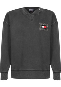 Felpa grigia in cotone, con colletto a girocollo, polsini e orlo a coste, con la scritta "TOMMY JEANS 1985" ricamata sulla parte anteriore.