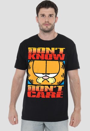 Black cotton t-shirt featuring a large cartoon cat graphic with the text “DON'T KNOW DON'T CARE” in bold red and yellow colors. Short sleeves.