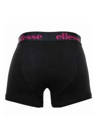 Boxer noir pour homme avec une large ceinture portant le nom de la marque « ellesse » en lettres roses.