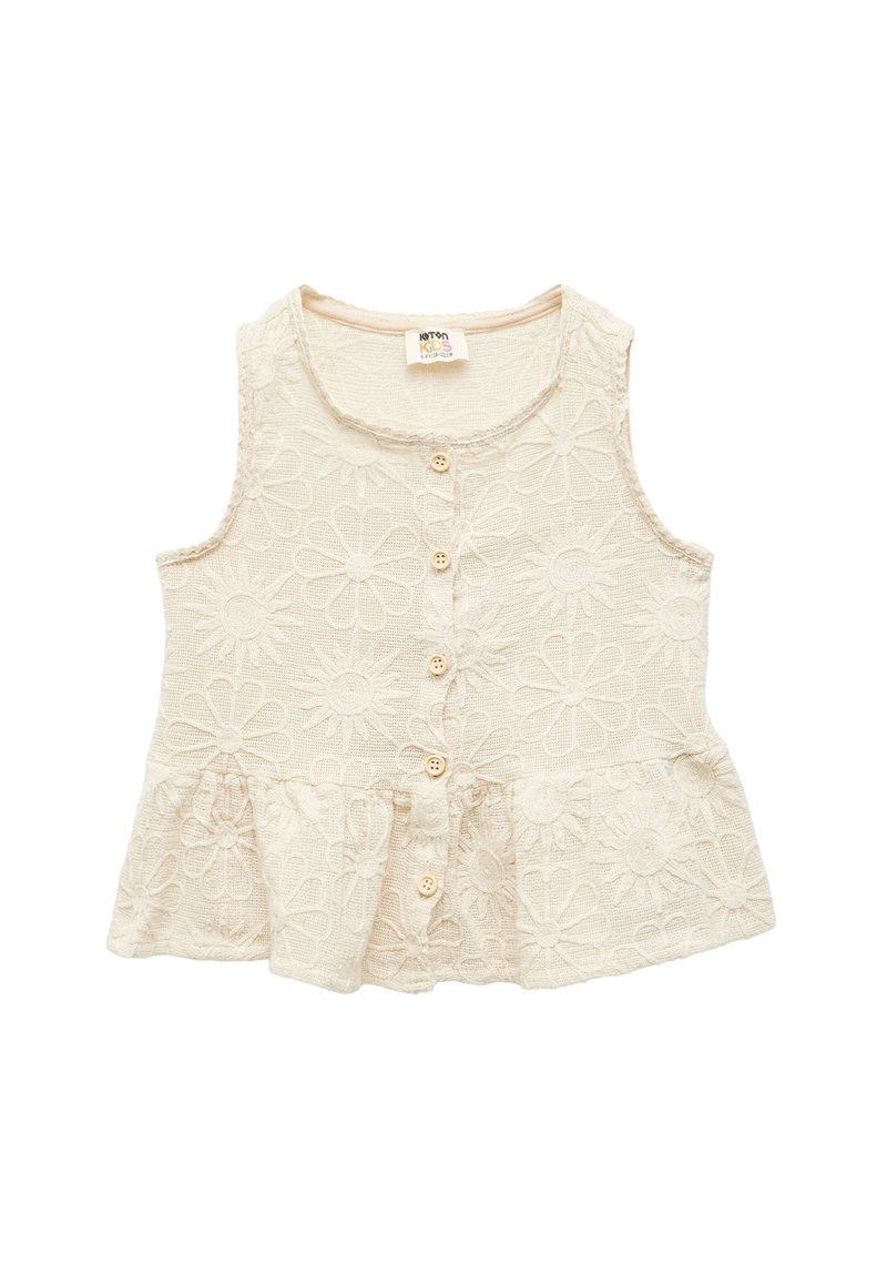Beige ærmeløs børnetop med blomsterbroderi, rund halsudskæring og knaplukning foran. Udvidet peplum-kant med tekstureret stof.