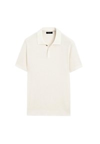 Polo a maniche corte in tessuto a maglia color crema, con colletto piatto, patta con due bottoni e design a trama testurizzata.