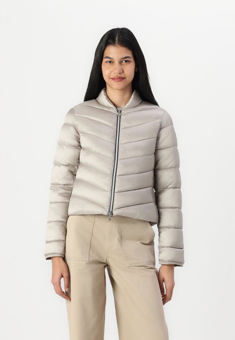 Light gray puffer jacket with a high collar, horizontal chevron stitching, and a front zipper. Smooth, shiny fabric with a cropped design.