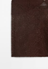 Dark brown lace fabric with intricate floral and wave patterns, small holes creating a delicate and textured design.