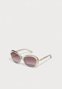 Ochelari de soare cu un cadru semicristalin de aur deschis, formă ovală, lentile gradient violet, detalii din metal auriu și brațe subțiri din argint.