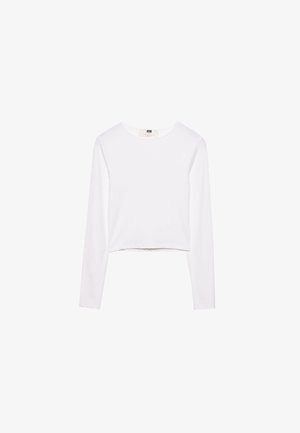 Valkoinen pitkähihainen crop-top, joka on valmistettu pehmeästä kankaasta. Siinä on pyöreä pääntie ja yksinkertainen, tyylikäs muotoilu ilman kuvioita tai koristeita.