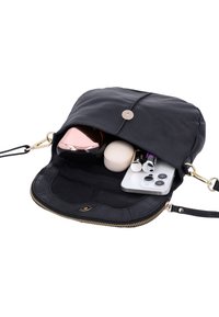 Black leather purse open to show contents including smartphone, two lipsticks, round compact case, and metallic rose gold bottle.