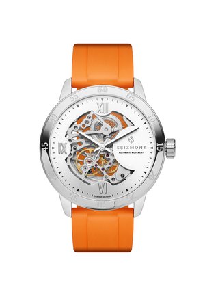 Harmaa analoginen rannekello, oranssi kumiranneke, osittainen skeleton-kellotaulu, jossa näkyy rattaat, roomalaiset numerot kohdissa 12, 6 ja 9 sekä "Seizmont"-merkki.