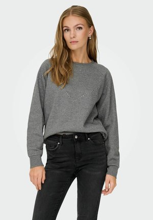 Grijze sweatshirt van zacht materiaal, met een V-vormige rij kleine zilveren studs over de voorkant; lange mouwen en een relaxte pasvorm.