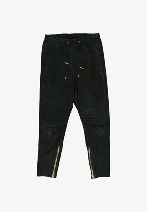 Pantalon de jogging noir avec taille à cordon, panneaux matelassés aux genoux et fermetures éclair dorées au bas des jambes.