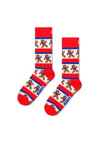 Red socks featuring gingerbread men patterns on a cream background, accented with blue and red stripes, and "HAPPY" text on the blue band.