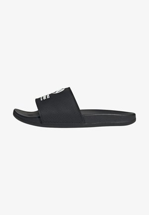 Black slide sandals feature a perforated upper with a wide strap, textured footbed, and a smooth outsole for comfort and grip.
