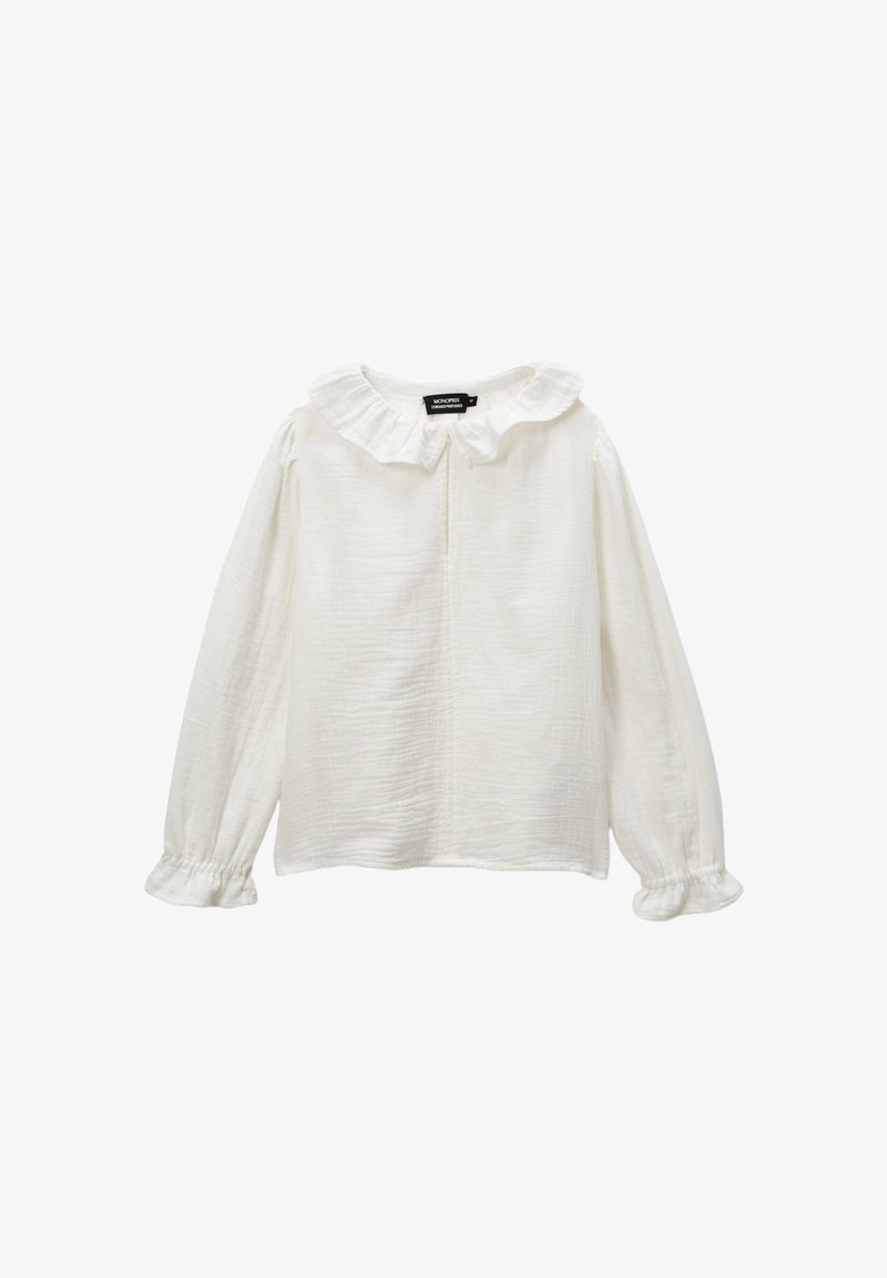 Blouse blanche à manches longues avec un col volanté, un tissu texturé, des poignets froncés et un plastron à l'avant. Design simple et épuré.
