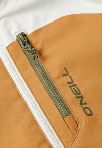Orange and white jacket fabric with a textured finish; features a green zipper and branded lettering in dark green.